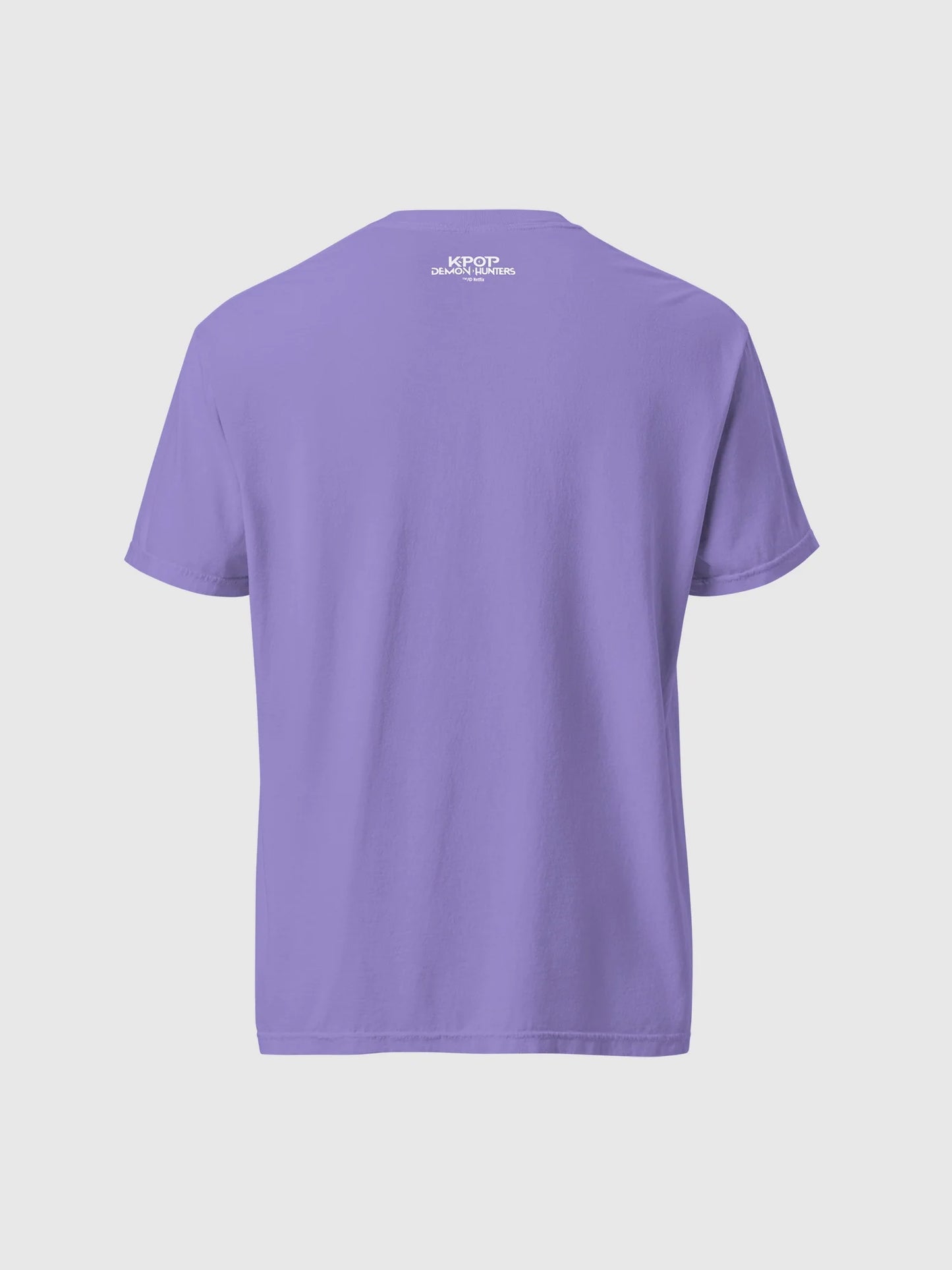 A fan wearing the oversized HUNTR/X tour shirt at a concert, showcasing the relaxed comfort-colors fit