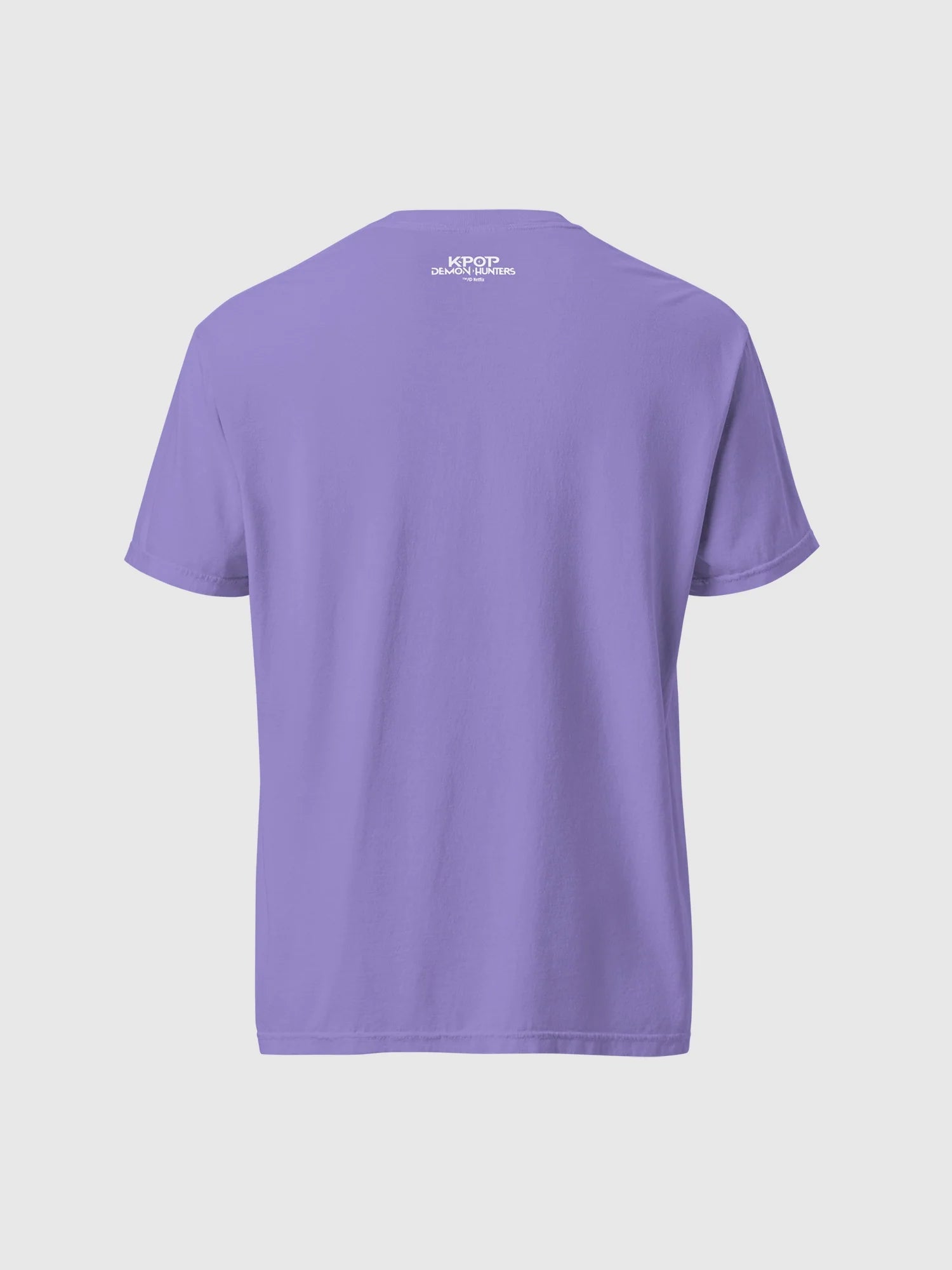 A fan wearing the oversized HUNTR/X tour shirt at a concert, showcasing the relaxed comfort-colors fit