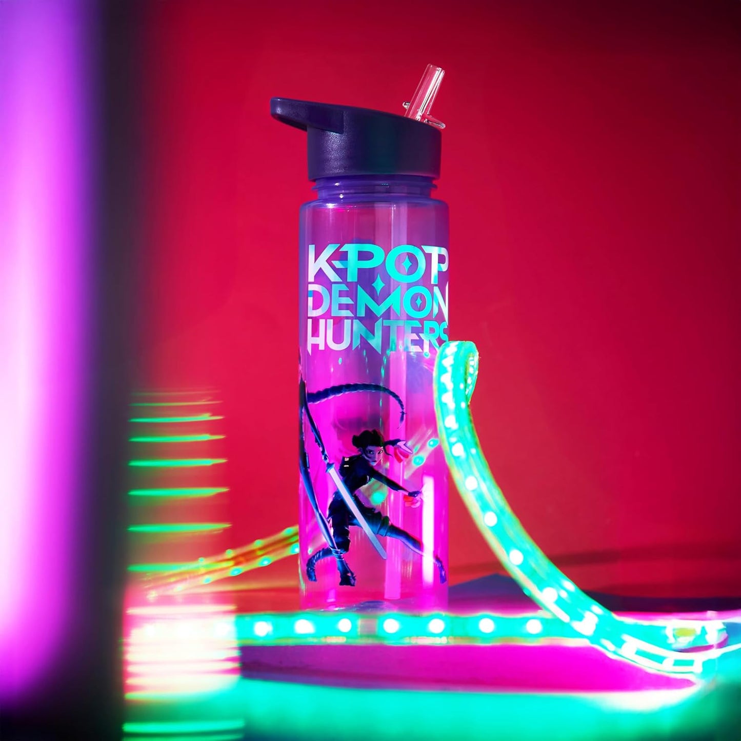 Fan holding Rumi Huntrix water bottle at school — lifestyle shot